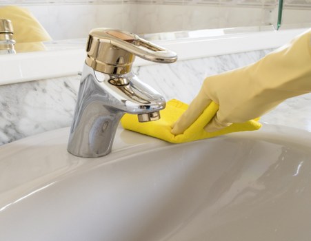 Domestic cleaner preparing a kitchen and living area in SW12