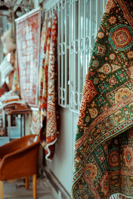 Close-up, ground-level view of a carpeted hallway in a residential or commercial property, featuring a beige textured carpet that appears clean and well-maintained. The hallway walls are decorated wit